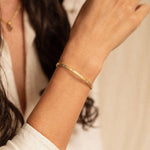 18K gold eternity cuff worn on wrist — White Sapphires- artisan handcrafted fine jewelry — Sun Rae
