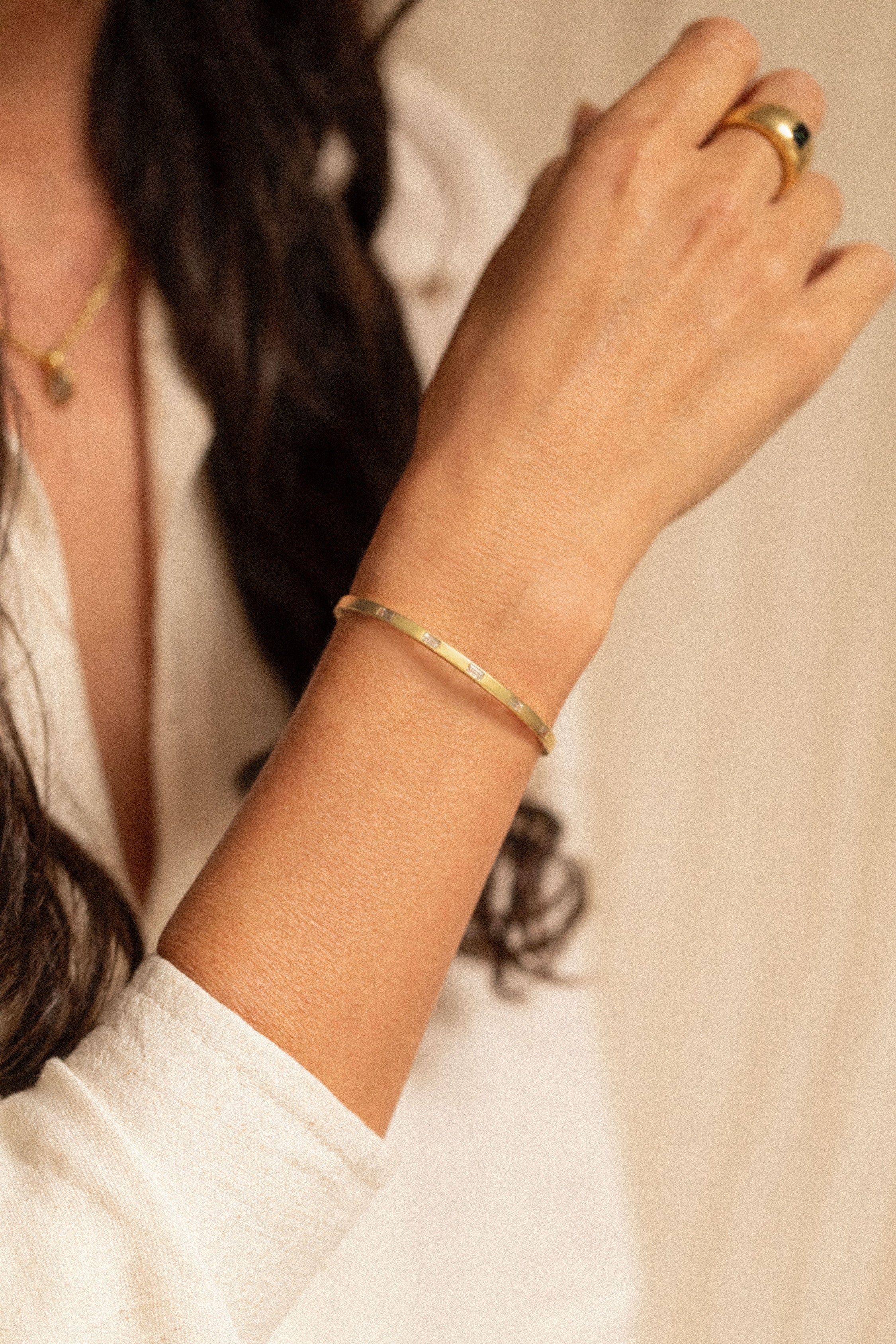18K gold eternity cuff worn on wrist — White Sapphires- artisan handcrafted fine jewelry — Sun Rae
