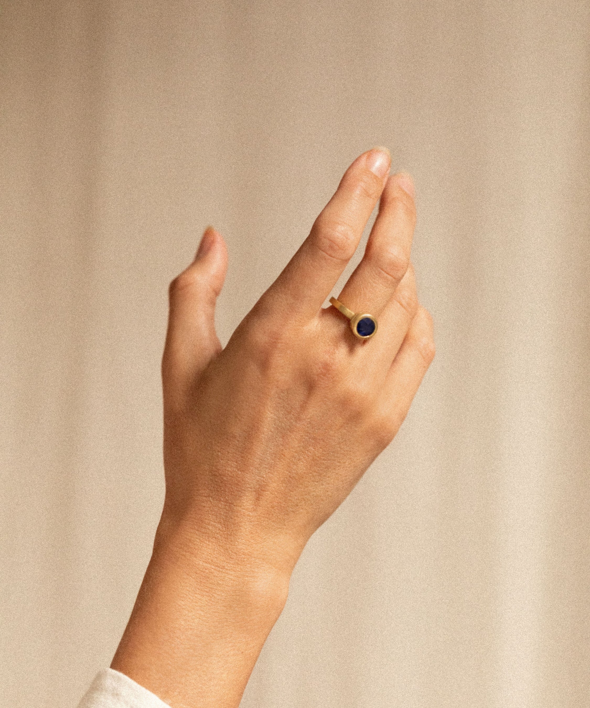 18K gold halo ring with diamonds and blue sapphire worn— handcrafted diamond halo ring — artisan fine jewelry — Sun Rae
