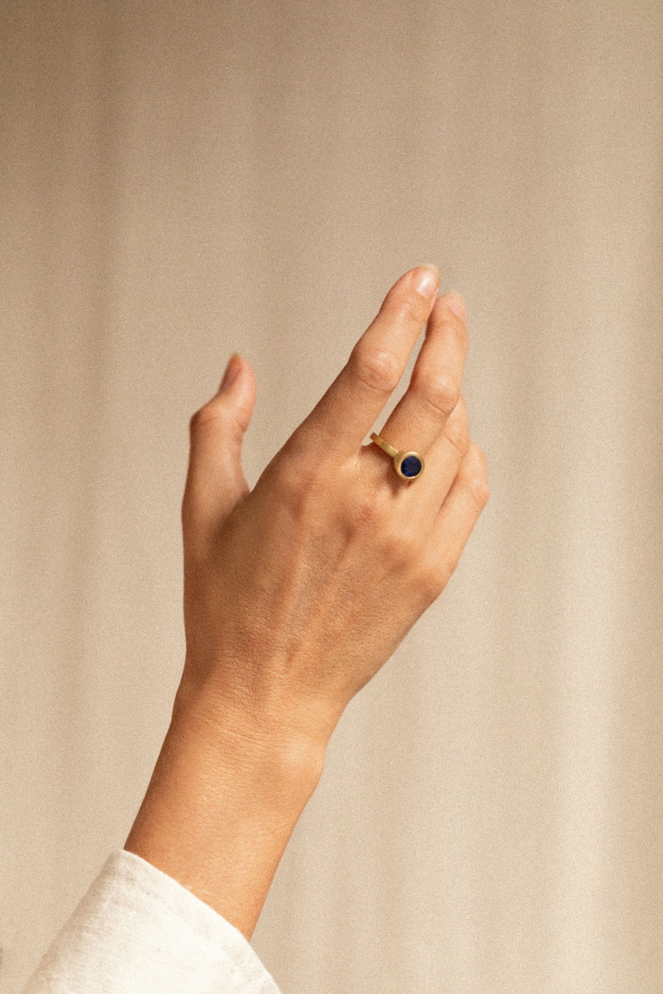 18K gold halo ring with diamonds and blue sapphire worn— handcrafted diamond halo ring — artisan fine jewelry — Sun Rae