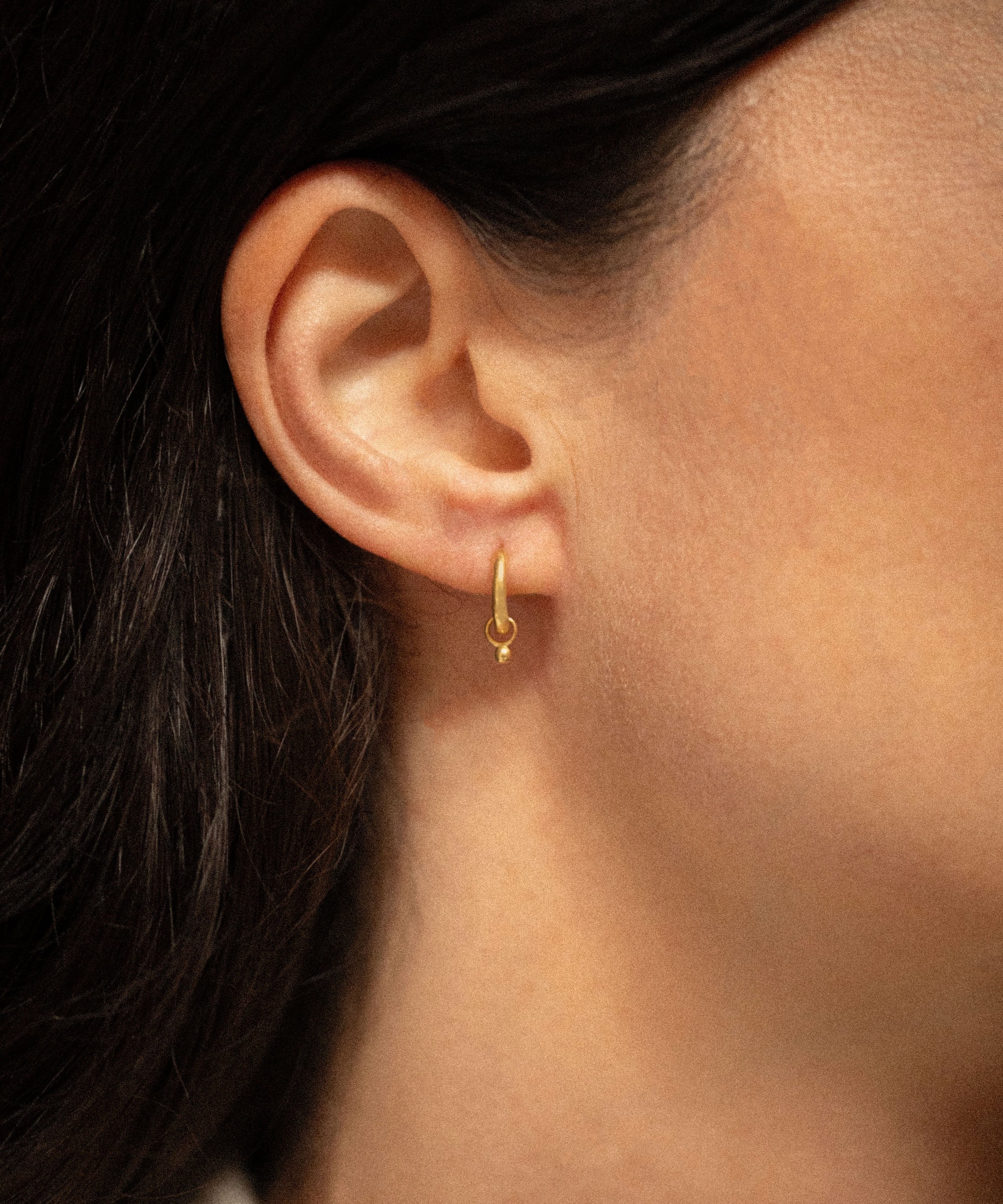 18K gold Surya huggies worn — artisan handcrafted gold earrings — Sun Rae