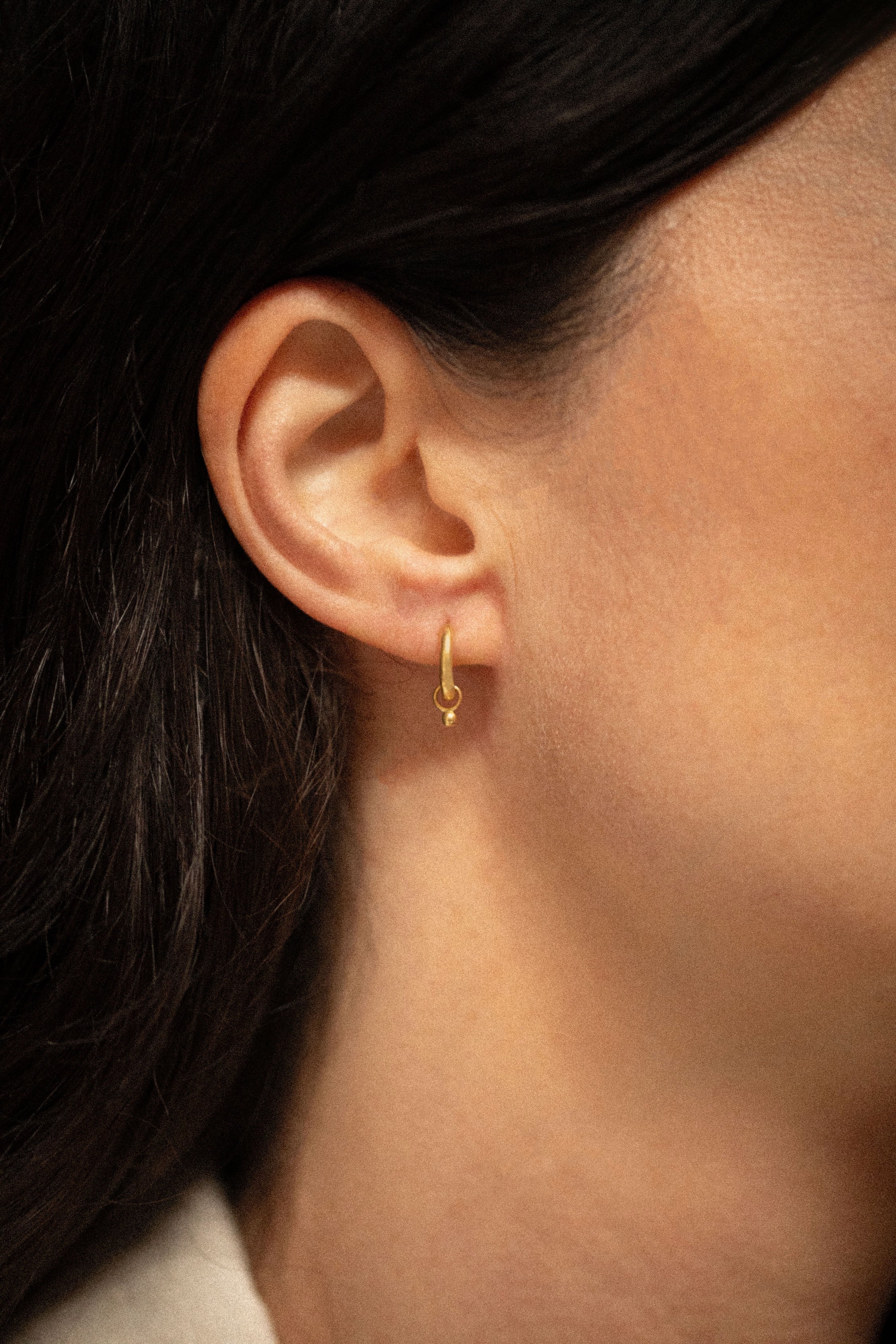 18K gold Surya huggies worn — artisan handcrafted gold earrings — Sun Rae