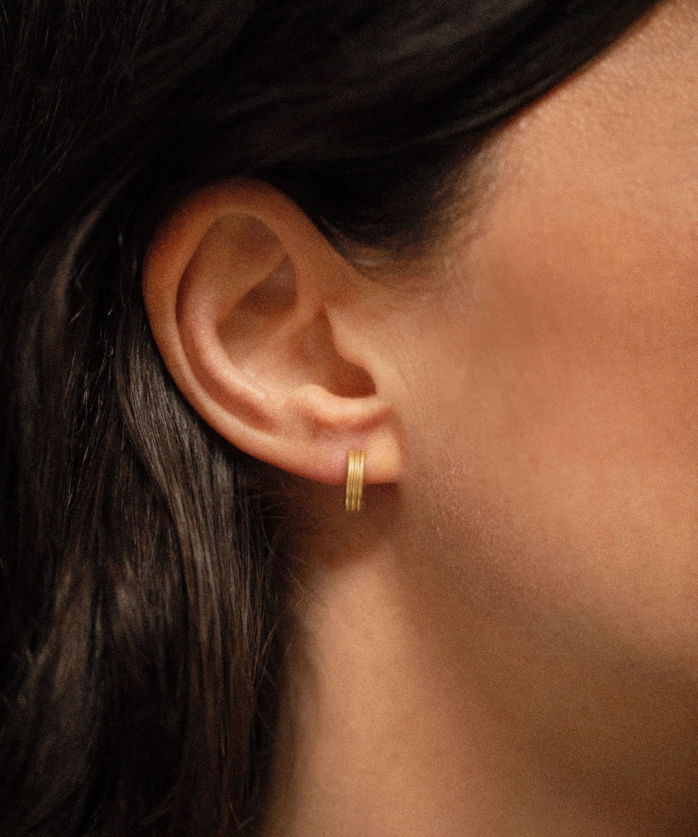 18K gold Trinity huggies worn — artisan handcrafted gold earrings — Sun Rae

