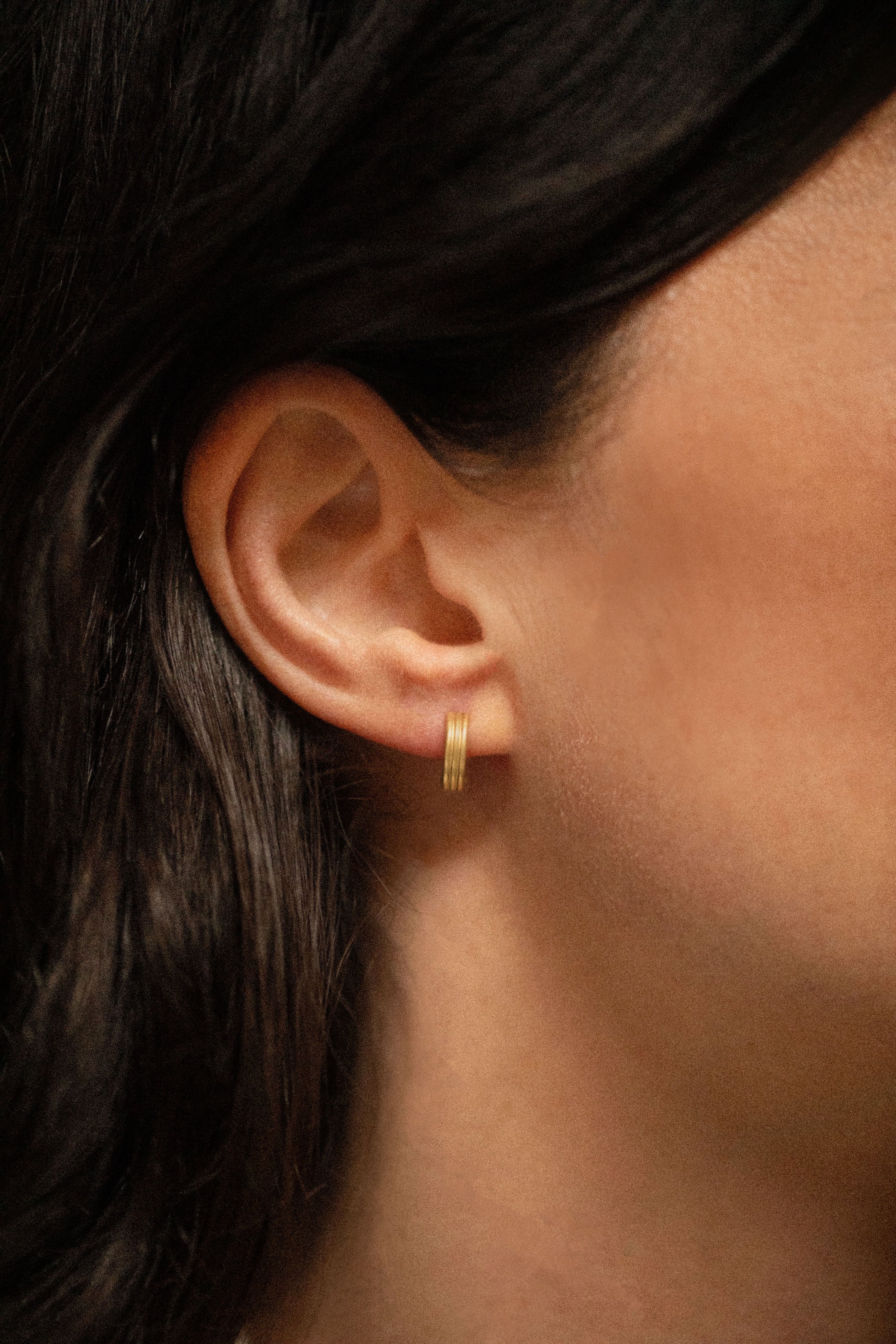 18K gold Trinity huggies worn — artisan handcrafted gold earrings — Sun Rae
